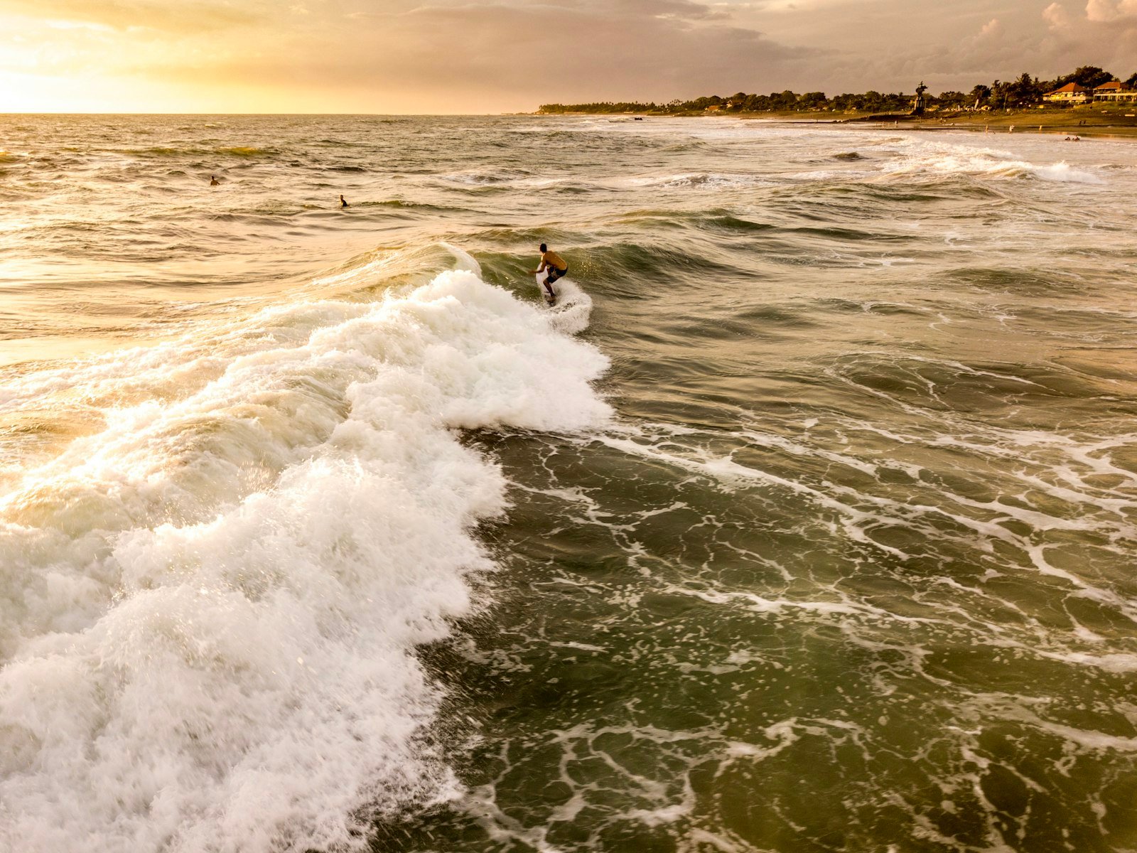 Surfer on a wave at Canggu, Bali